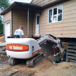 Excavating to expose the foundation walls and footings for a replacement job in Slidell
